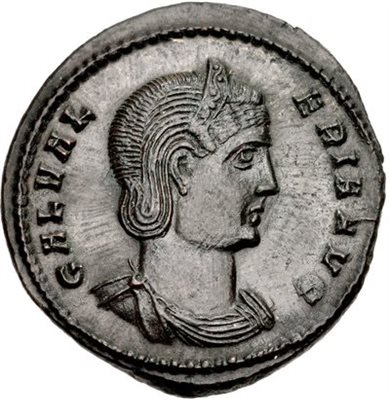 Roughly shaped ancient silver-coloured coin displaying a head in profile