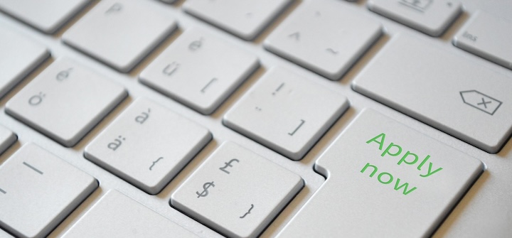 Close up view of a laptop keyboard with 'Apply now' on the enter key