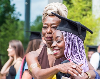 Mother hugging daughter at her graduation