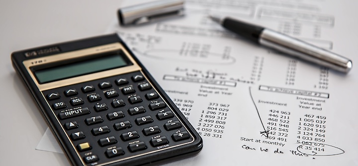 Close up view of a calculator and documents