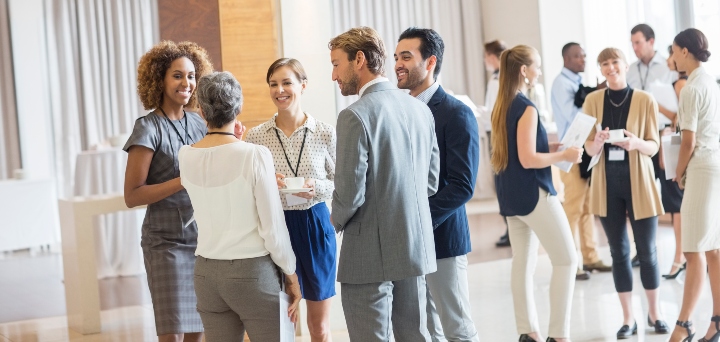 Wide range of people from different backgrounds talking at work