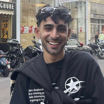 Stephen Dhariwal smiling and standing on a street in Derby