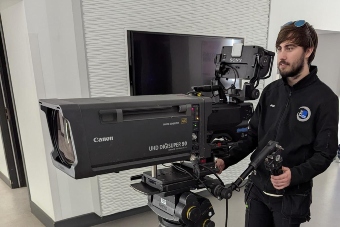Joseph Banks using a camera to film a show