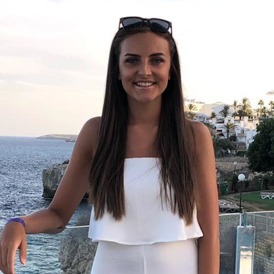 Portrait of Daisy Slater overlooking the sea and smiling