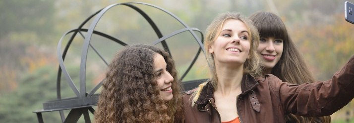 Female undergraduate students taking a selfie in the Millennium Garden, University Park 714x249
