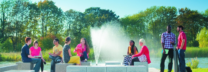 Undergraduate students in front of the fountain, Jubilee Campus 714x249