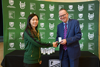 Yiyi Tao receiving award and shaking hands with Professor Jeremy Gregory