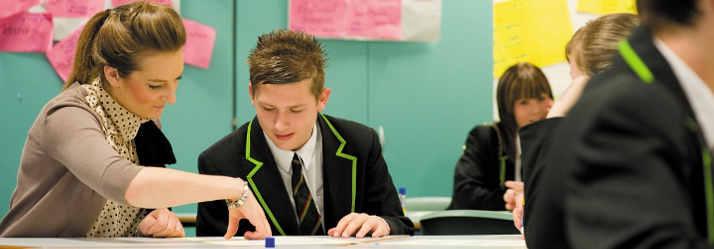 Female postgraduate student teaching pupils, Nottingham University Samworth Academy (NUSA) 714x249