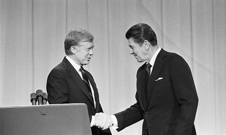 Carter and Reagan shake hands, black and white image