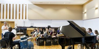 A band practices in the rehearsal hall