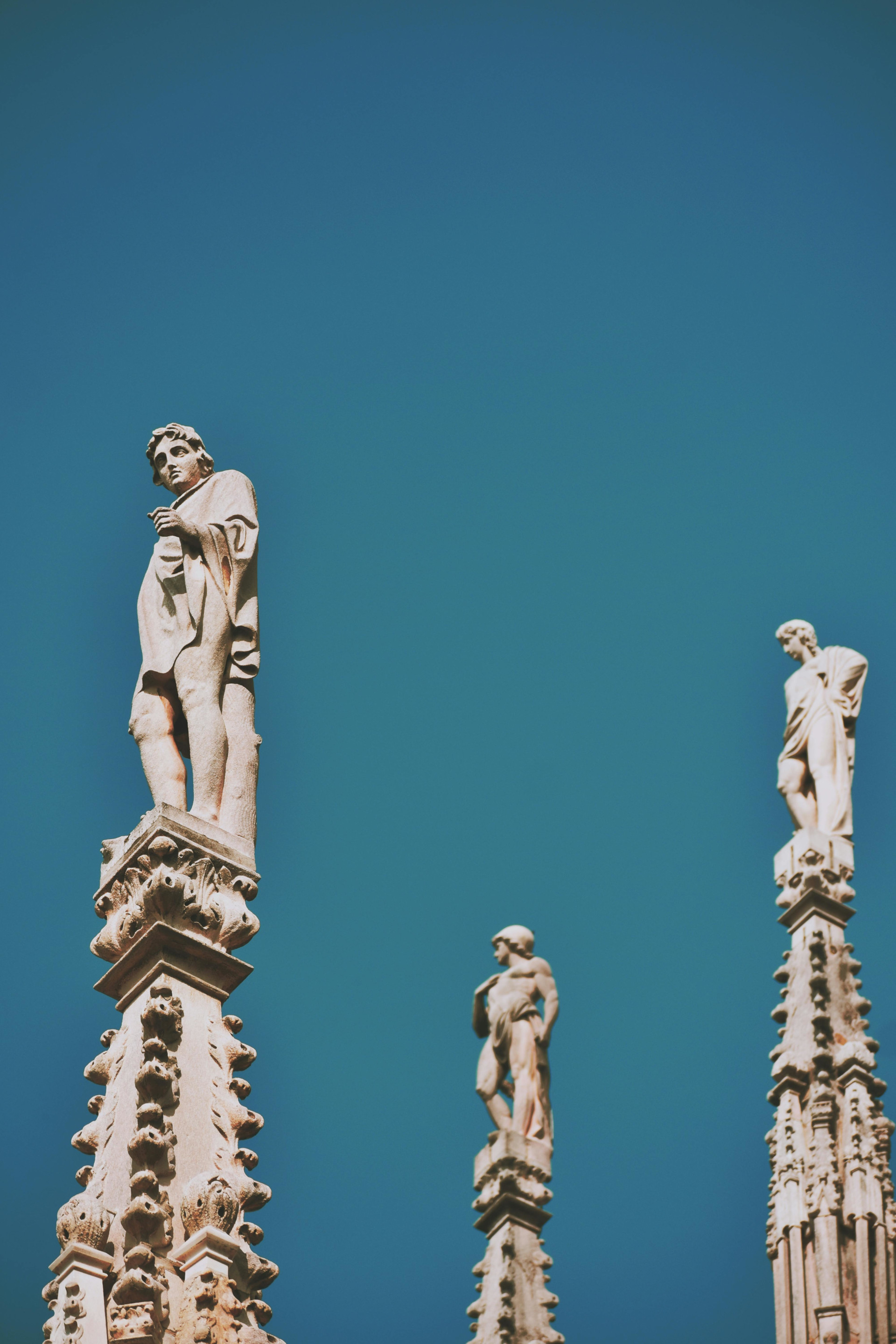 Group of ancient statues on top of columns