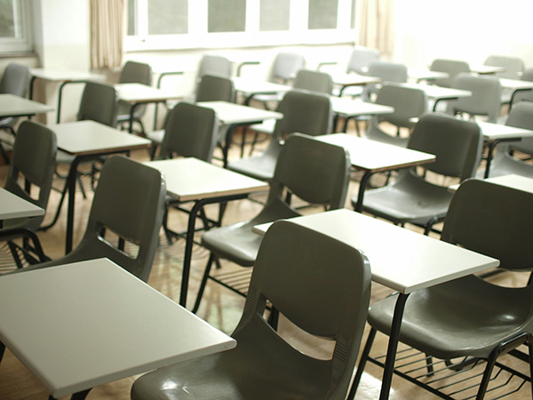 Empty desks and chairs in rows in an exam room