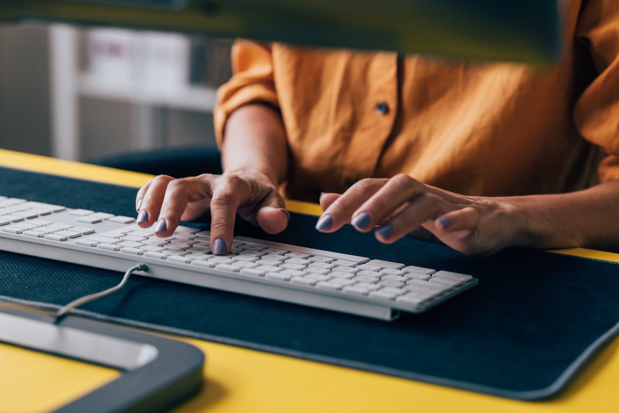 person typing at a computer