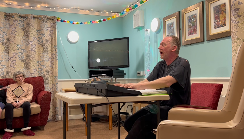 Cliff singing songs at a care home