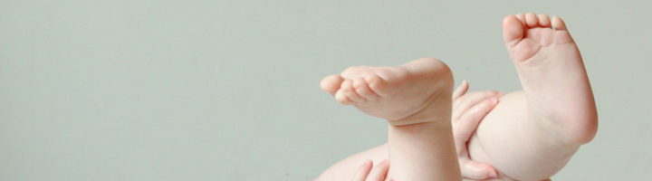 baby feet on gray background