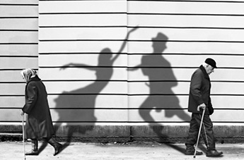 older people with the shadows of young dancers