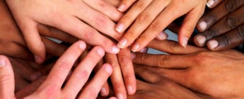 Hands of different skin tones touching each other in a circle