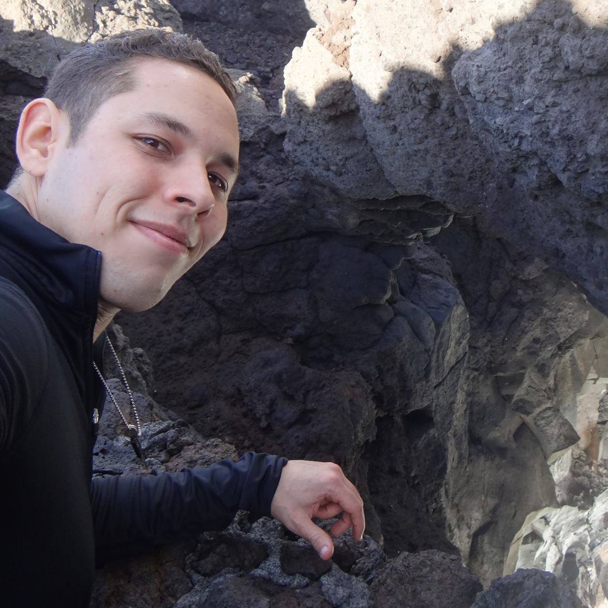 Luis Salazar Licea posing in front of a cave