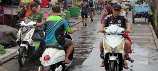 Road filled with electric mopeds in Indonesia