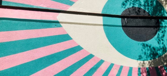 Colourful wall graphic of eyeball and bands of colour radiating outwards