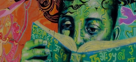 Colourful wall mural of close up of someone reading book