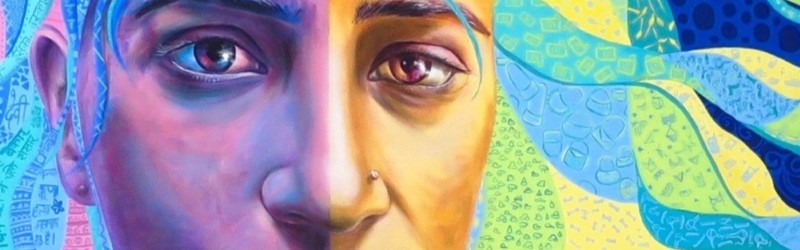 Close up of colourful mural including a face with nose piercing