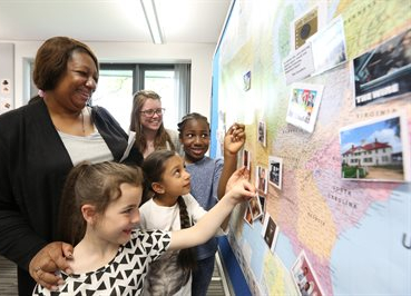 children looking at world map