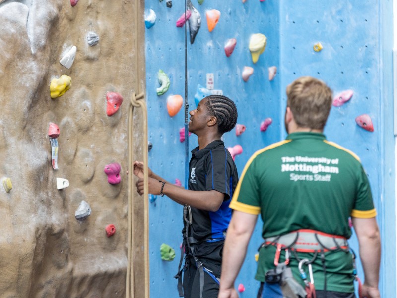 Pupil tries out climbing with an instructor at David Ross Sports Village