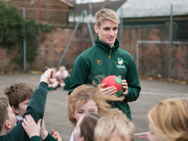 Student holds ball in school playground