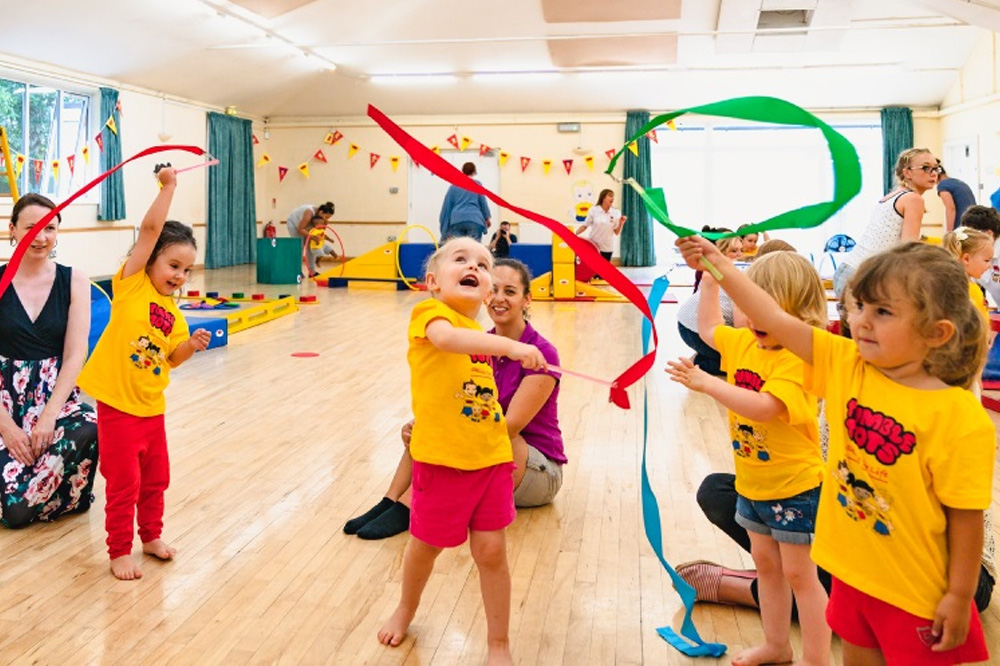Toddlers taking part in a Tumble Tots class.