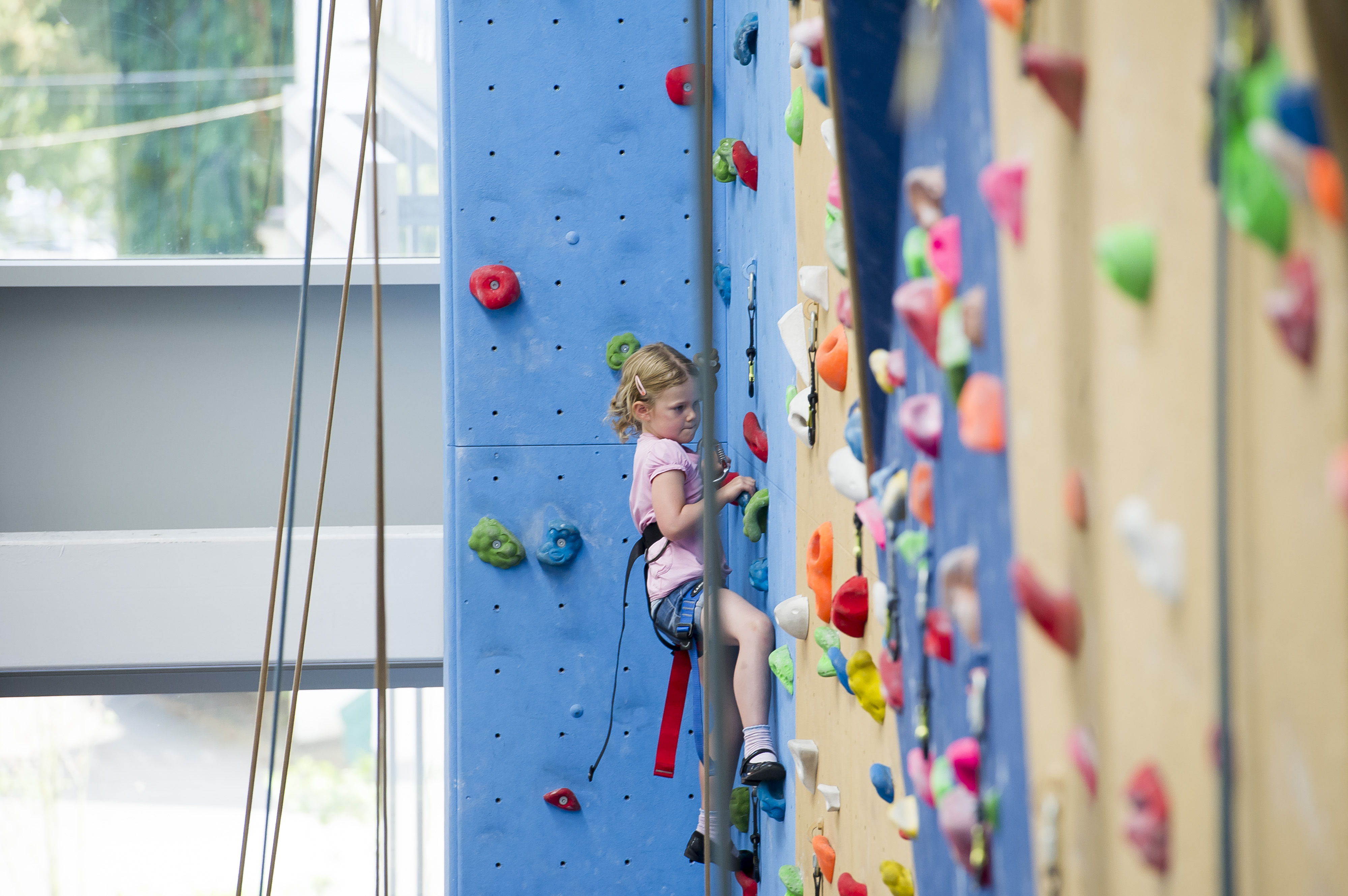 Young girl trying out climbing at David Ross Sports Village.