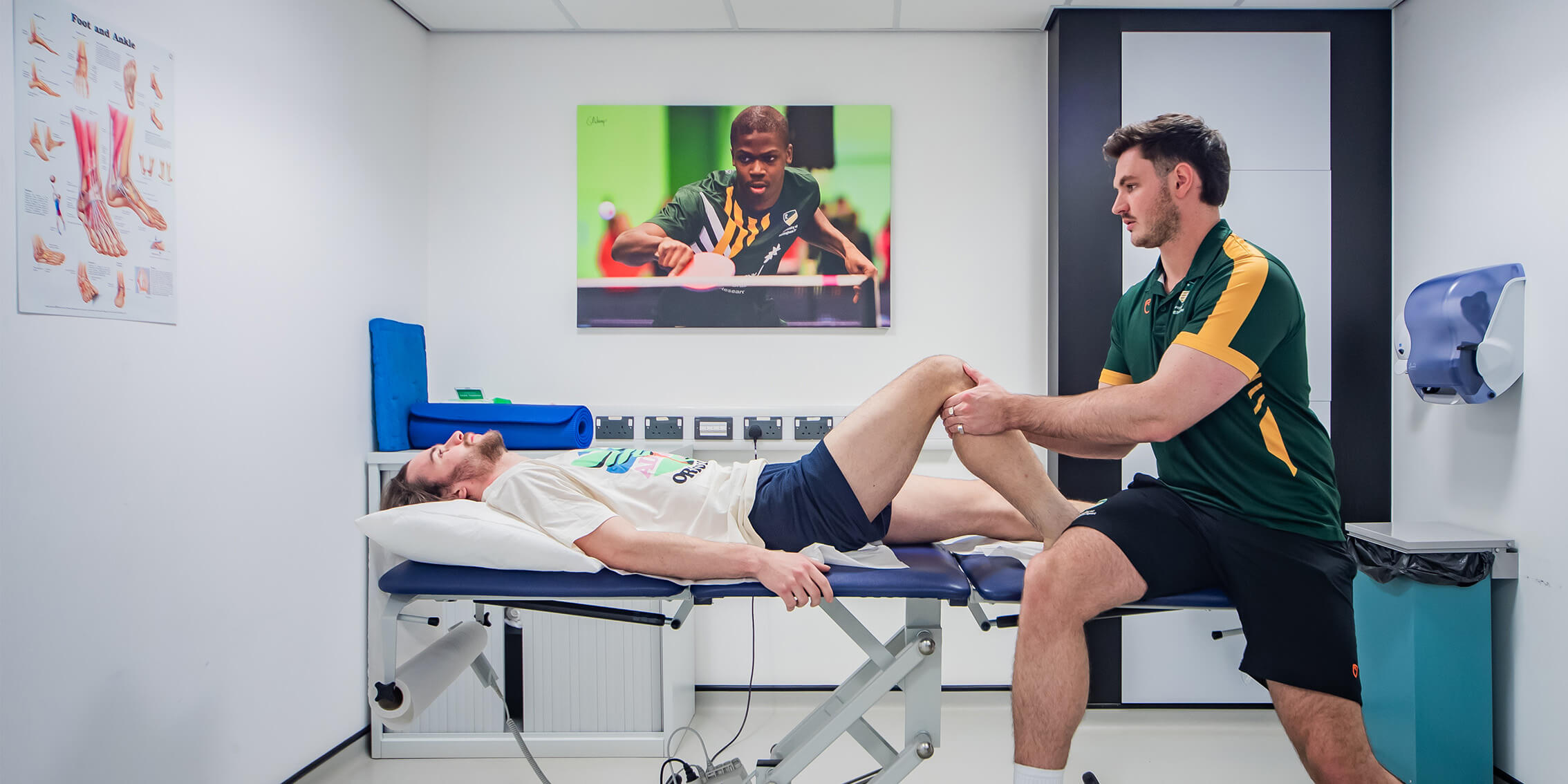 A physiotherapist working with a patient on a knee injury, in our Sports Injury Clinic