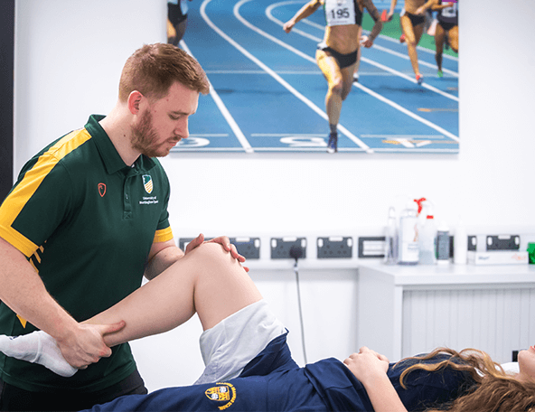 A physiotherapist providing treatment for a knee injury in the Sports Injury Clinic at David Ross Sports Village