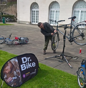 Dr Bike mechanic reapiring bikes outside Portland Building