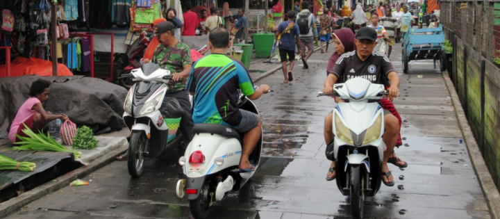 Photo of electric scooters run up and down Jalan Yos Sudarso in Agats, Asmat, West Papua (Irian Jaya), Indonesia.