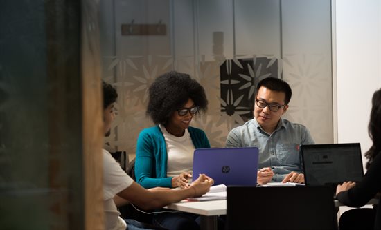 Students working together in small study booth