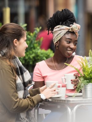 Students sitting outside cafe talking