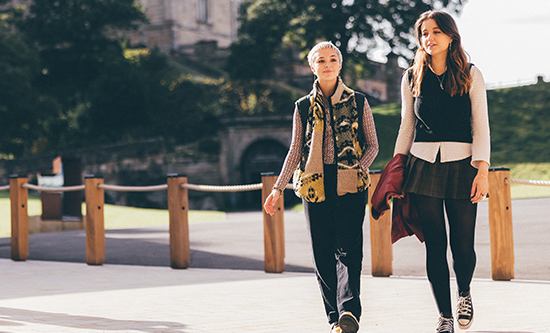 Two students walk on campus