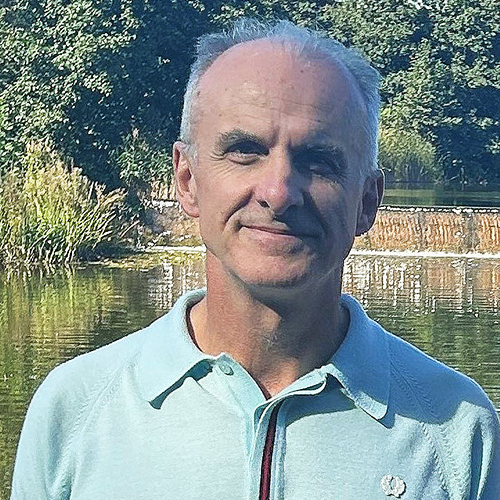 Head and shoulder image of Professor Marek Korczynski standing in front of pond on Jubilee campus