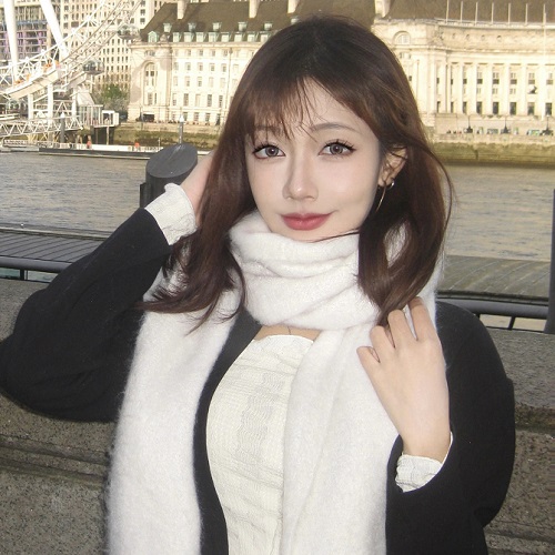 Photo of Xinyi Yang stood outside with the River Themes in the background.