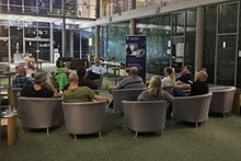 Participants from cohort 1 of Ultimate Scale Up sitting in a masterminding session in the hotel atrium