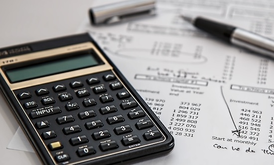 Calculator and papers on a desk