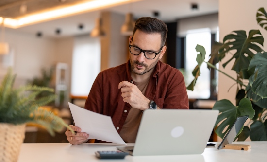 A man reading a document at work