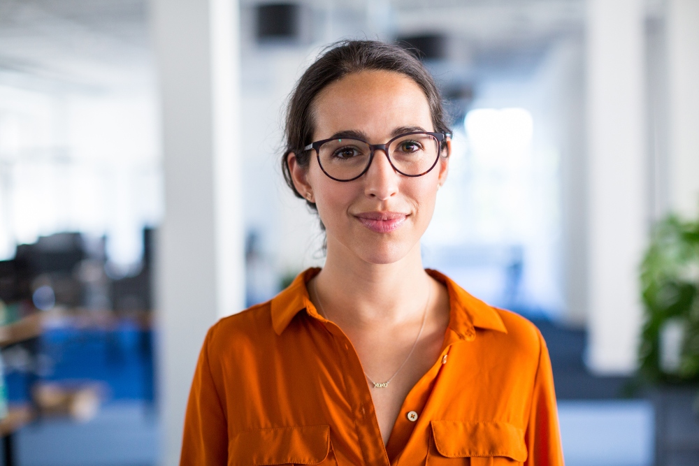 Woman in an office smiling at the camera