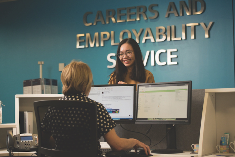 Professional sitting at a computer desk of careers and employability