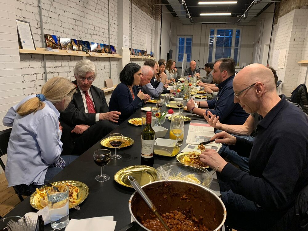 A photo of a community group eating together