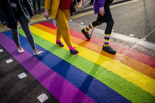 Students walking on the rainbow crosswalk on University Park Campus.