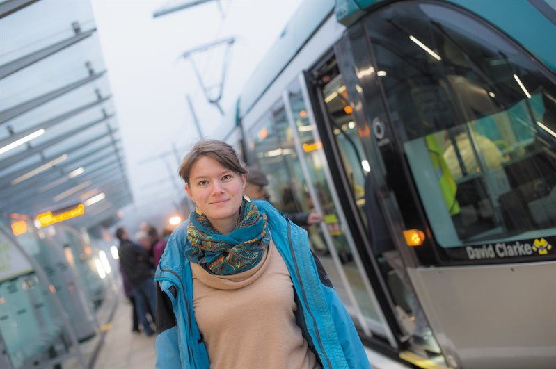 A student walking after getting off the tram