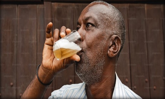 A man drinking a pint of beer