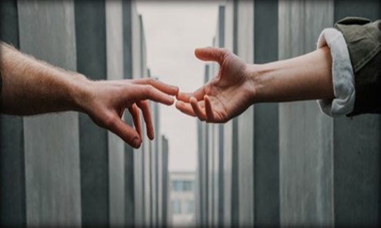 Two hands reaching out to each other